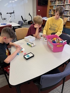 students play a game at a table