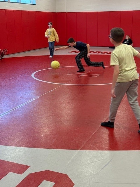 students playing gaga ball in the mat room