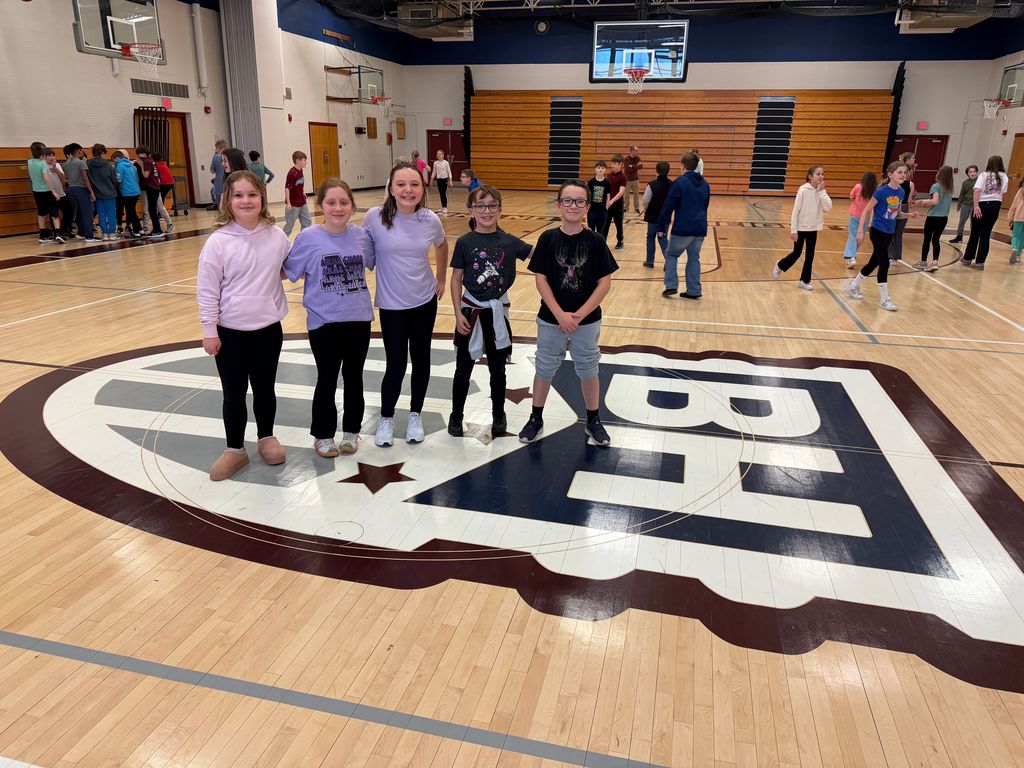 students stand together in the gym