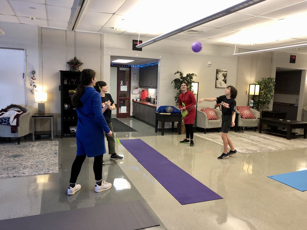 Students enjoy a game of indoor tennis.