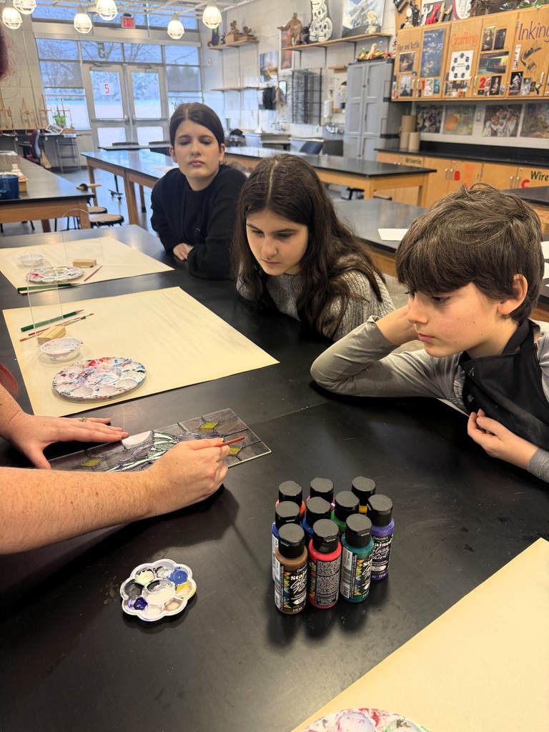 Students learn how to apply translucent paint.
