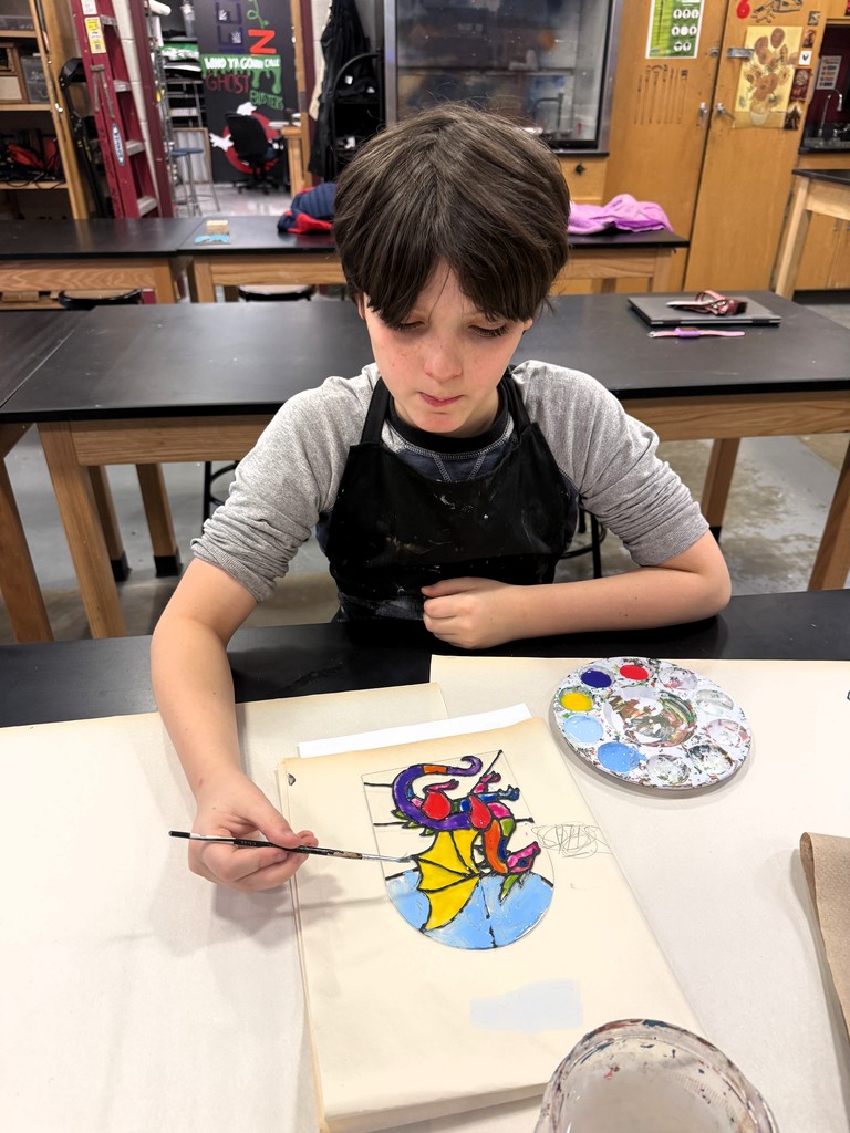 Students mixed paints to create brilliants colors for their creations.