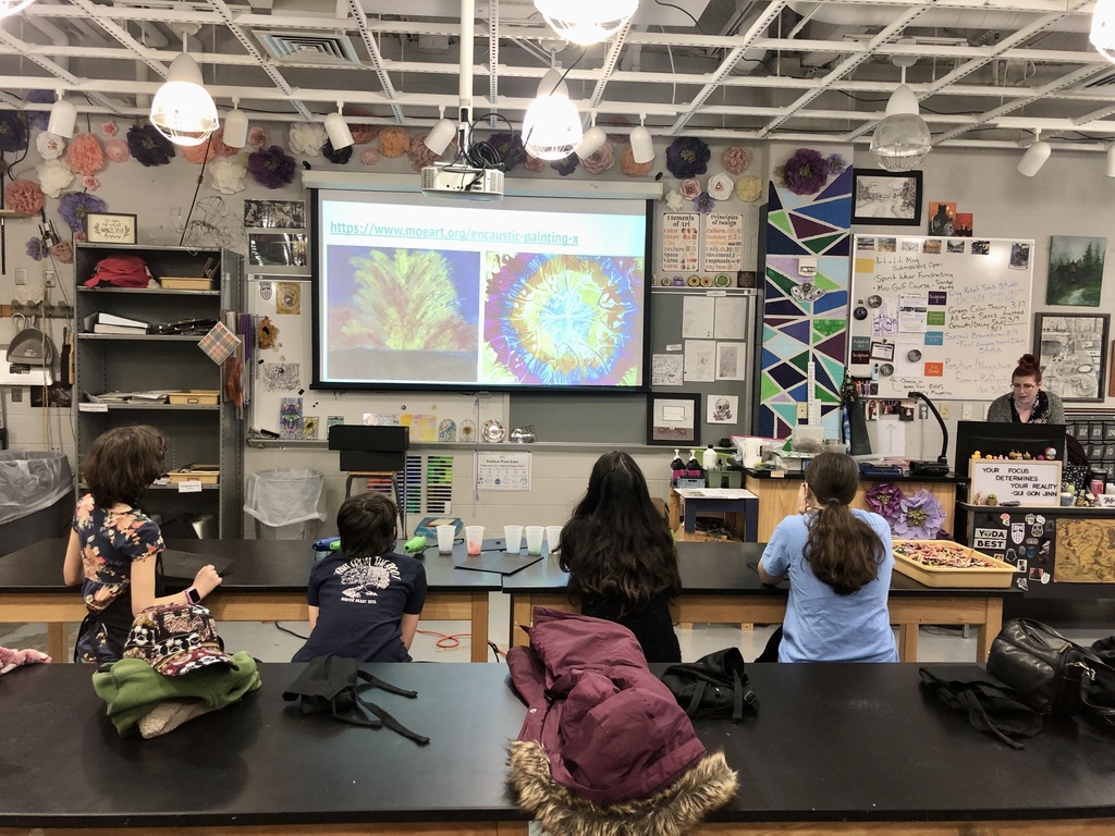 Students learning about encaustic drawing.