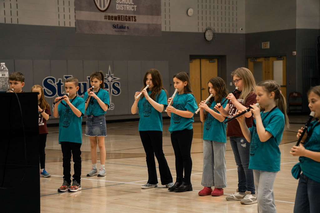 Grade 3 instrumentalists warming up at MIOS