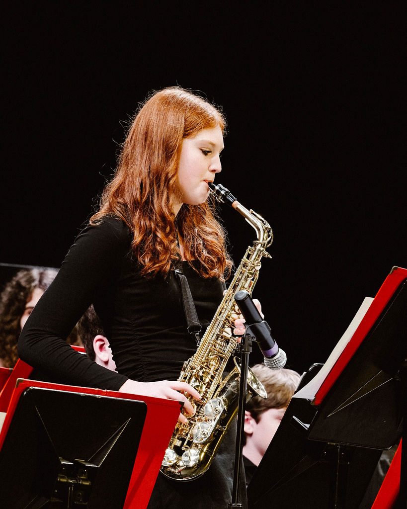 Student playing an alto saxophone solo at MIOS