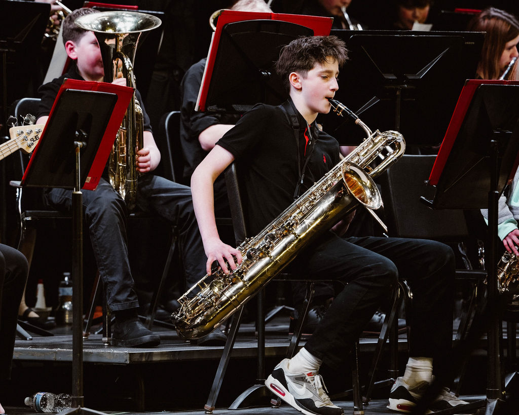 Student playing baritone saxophone at MIOS