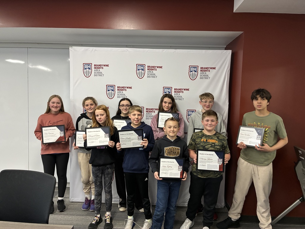 students stand smiling with certificates