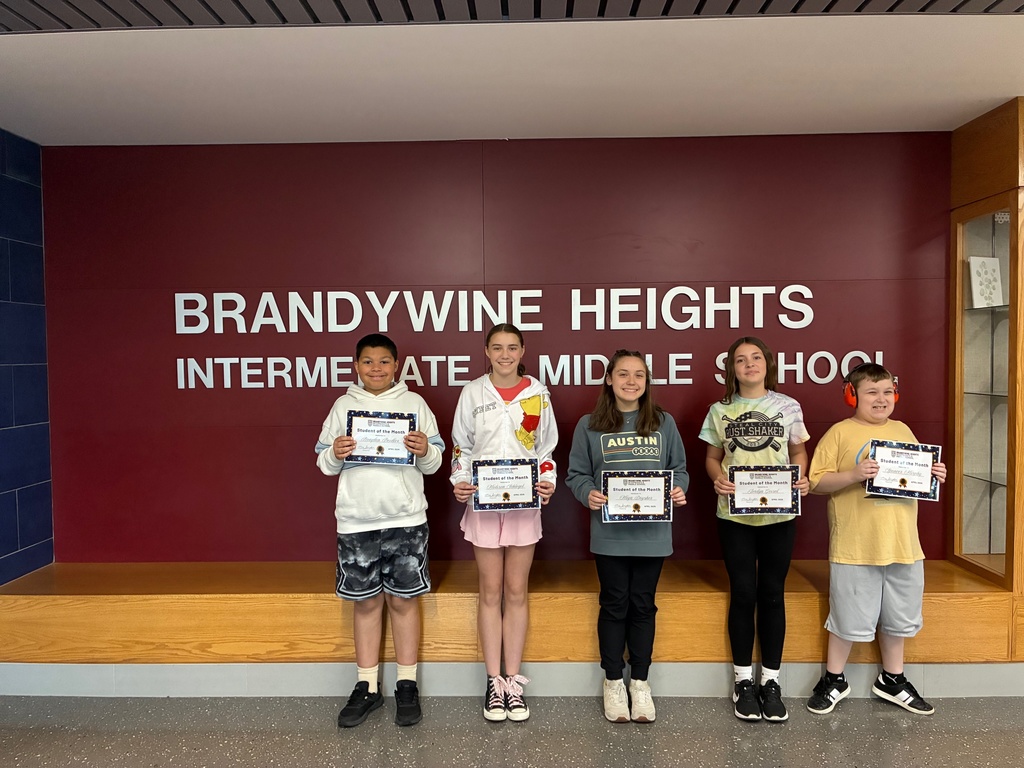 5 students stand smiling holding certificates