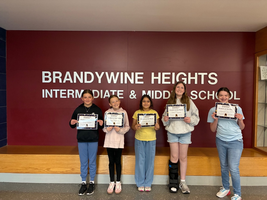 5 students stand smiling holding certificates