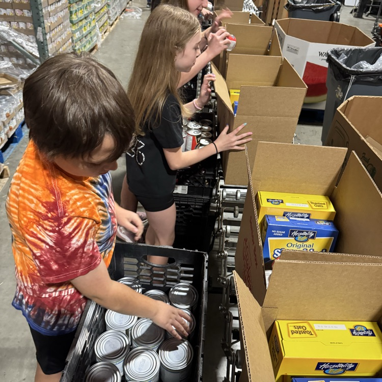 MS Student Council/Key Club packing senior boxes at helping harvest food bank.
