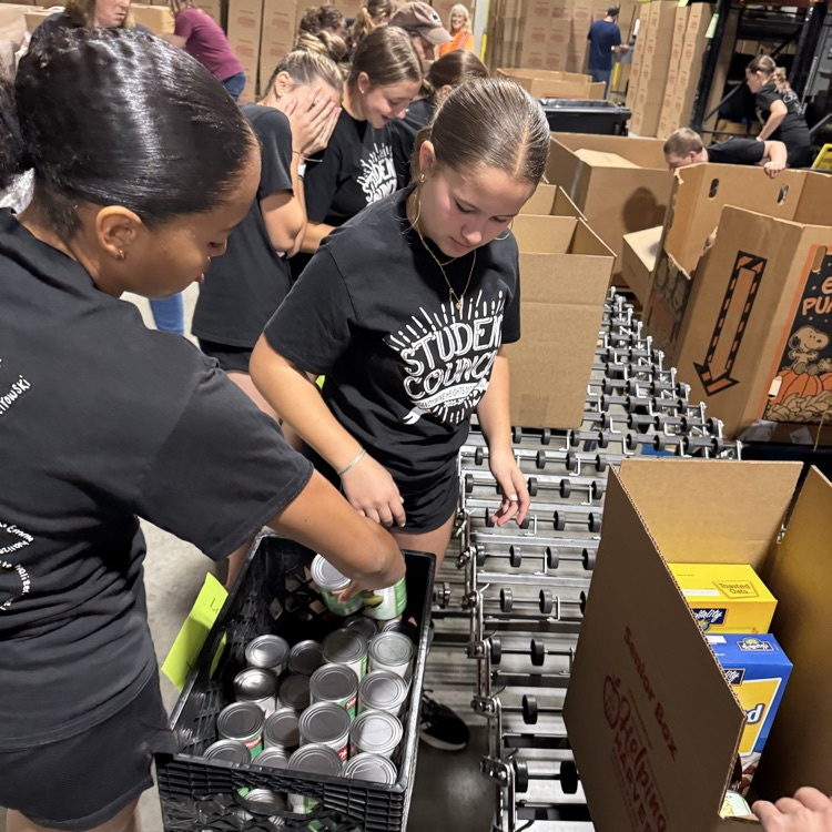 MS Student Council/Key Club packing senior boxes at helping harvest food bank.
