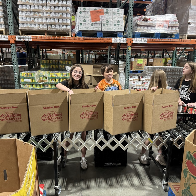 MS Student Council/Key Club packing senior boxes at helping harvest food bank.