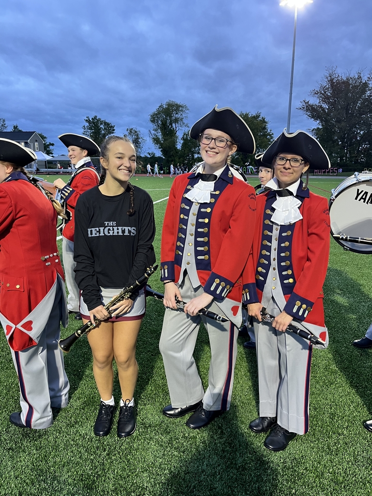 Marching Band students standing and posing before their performance
