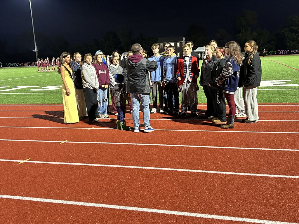 Chamber Singers performing the National Anthem on the track