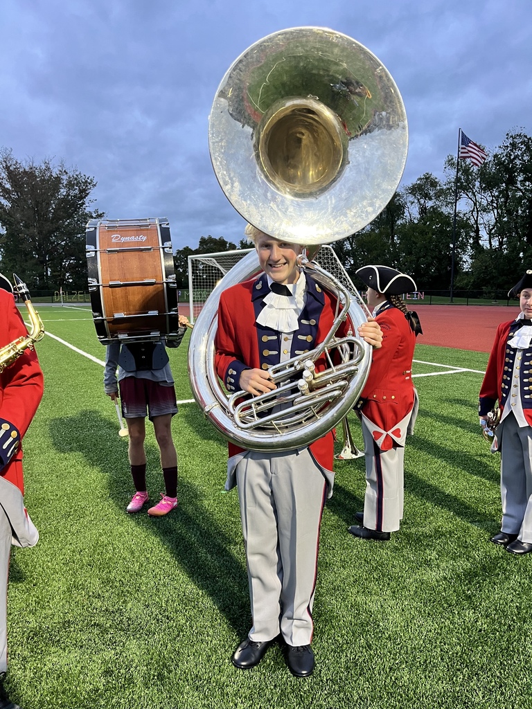 Marching Band student standing and posing on the field