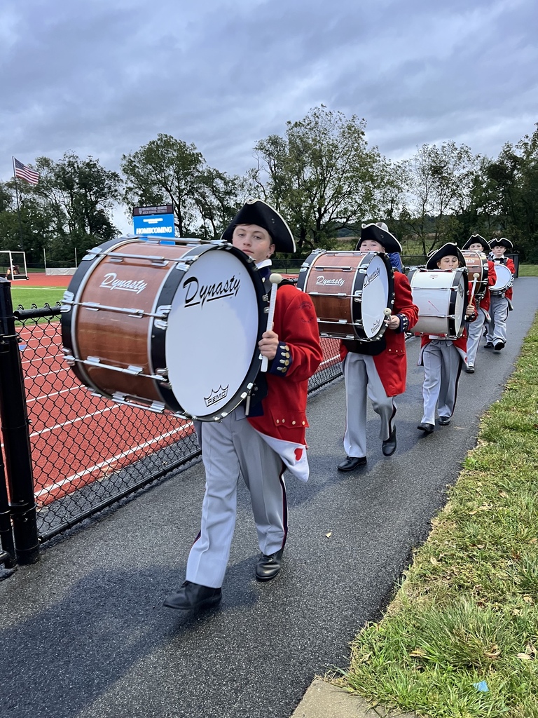 Drum line walking out onto the field for performance