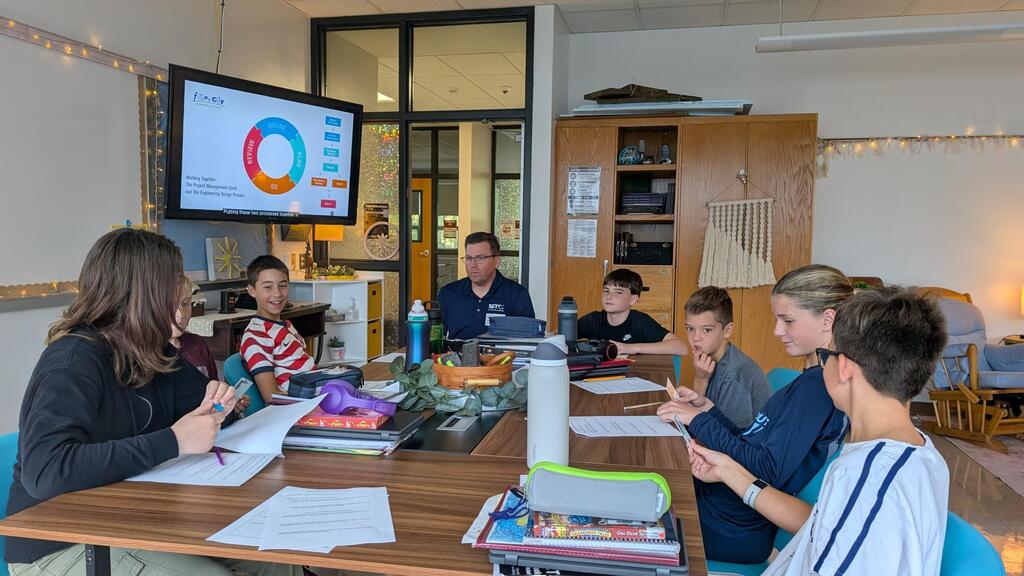 Students work with engineer mentor