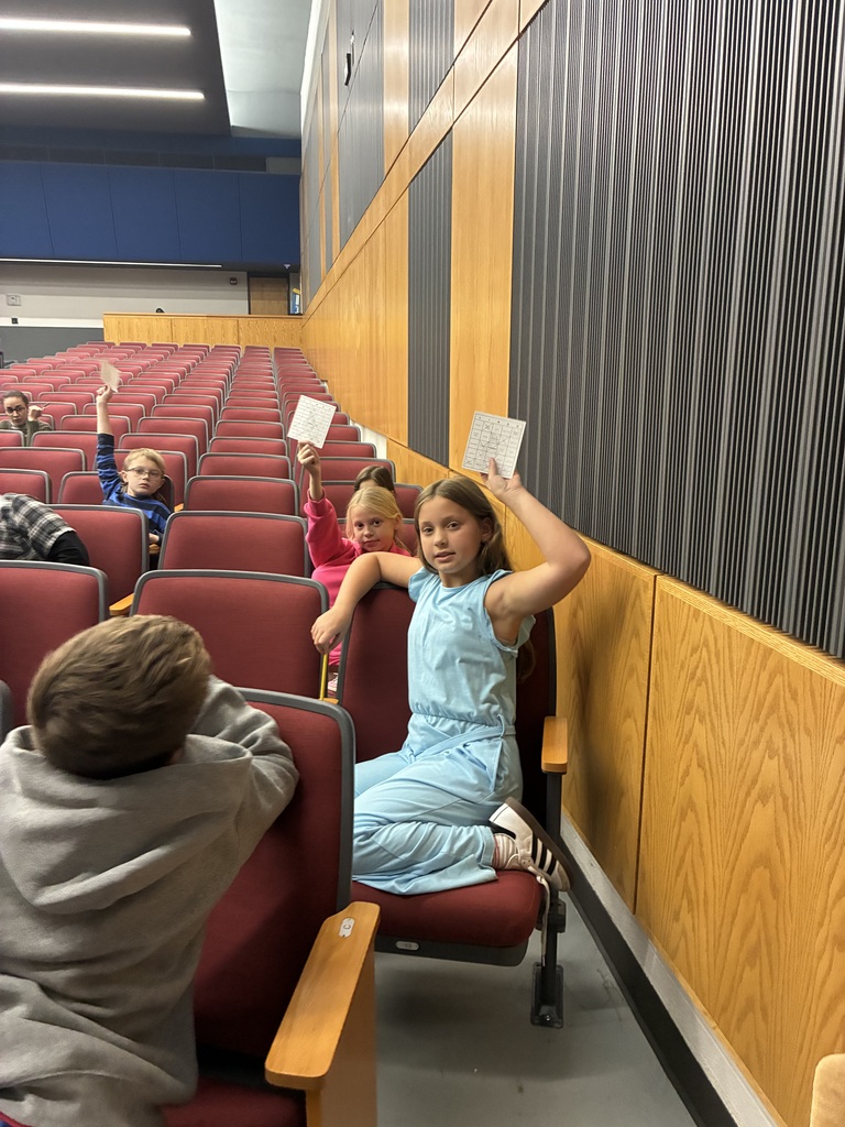 students holding up cards