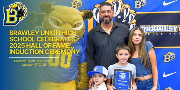Willy the wildcat poses for photo next to hall of fame inductee jacob sanchez.