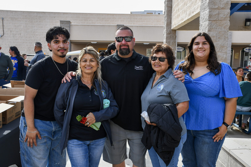 Senior students Saul and Aly stand alongside board members Joel, Estella and Gloria.