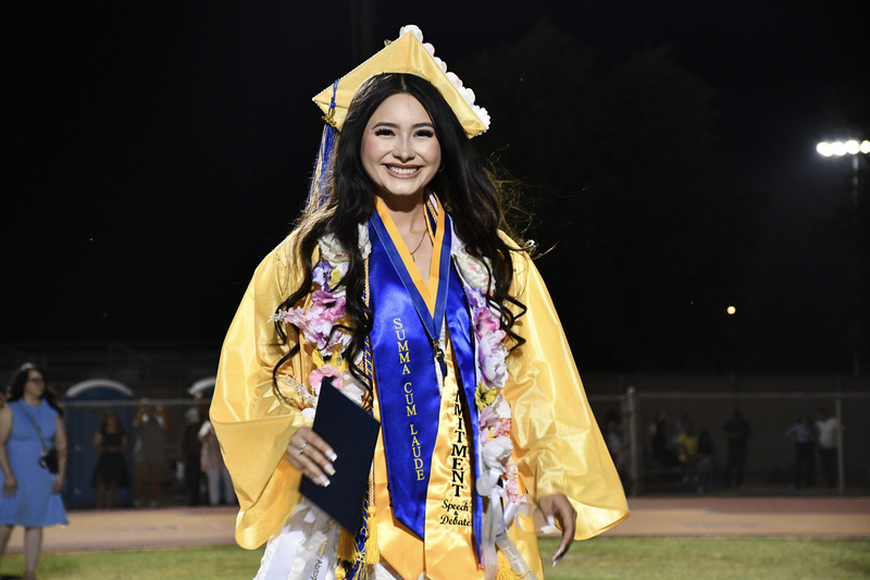 Graduate posed for photo with diploma