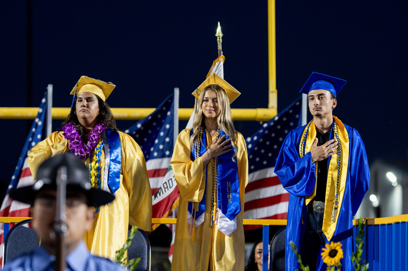 BUHS Graduates Aly Juarez, Demi Vogel and Gustavo Arias Ramirez stands alongside eachother on the stage.