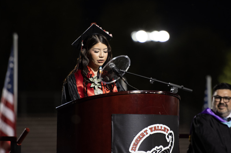 Student stands at podium and addresses the graduating class and guest.