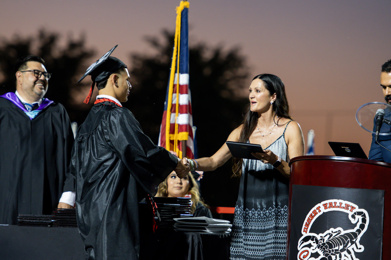 Student recieves award on stage at graduation