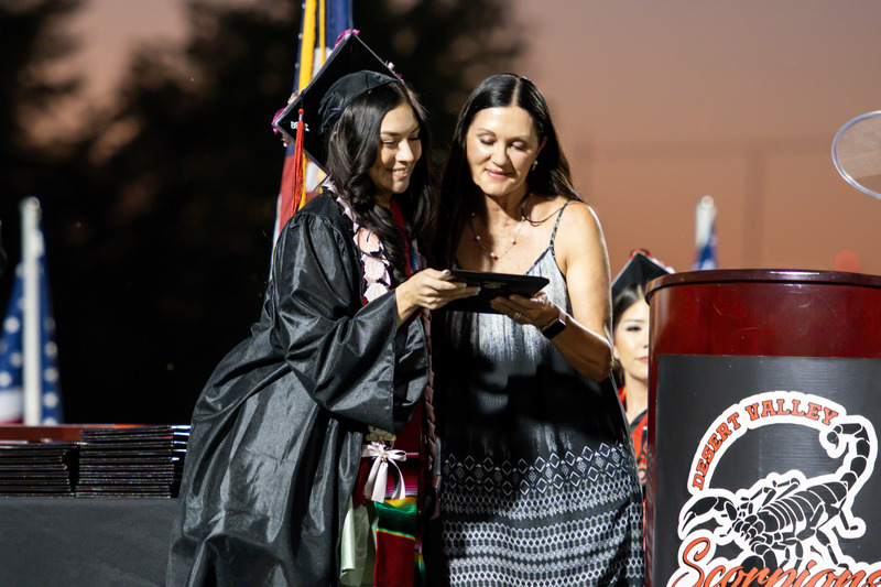Student hugs Mrs. Wells as she recieves her award.