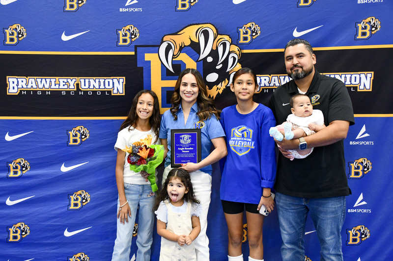 brawley union teacher mrs.nunez poses alongside her family with hall of fame award