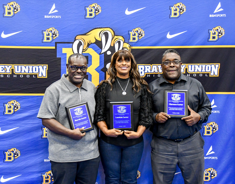 Hall of fame inductees Carter family pose for photo with hall of fame award
