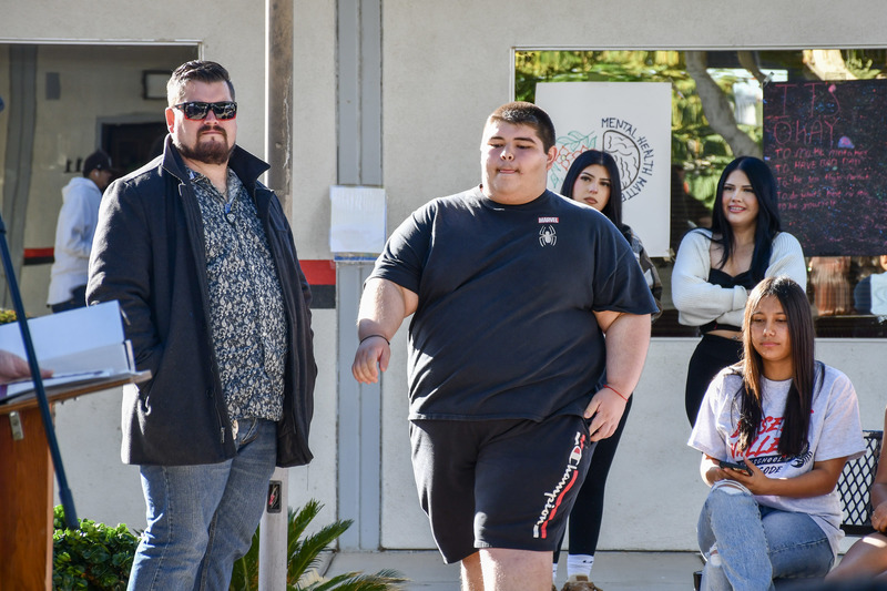 Student walks to stage to recieve certificate.