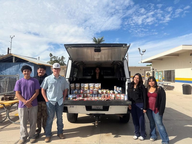 FFA students pose next to donated items.