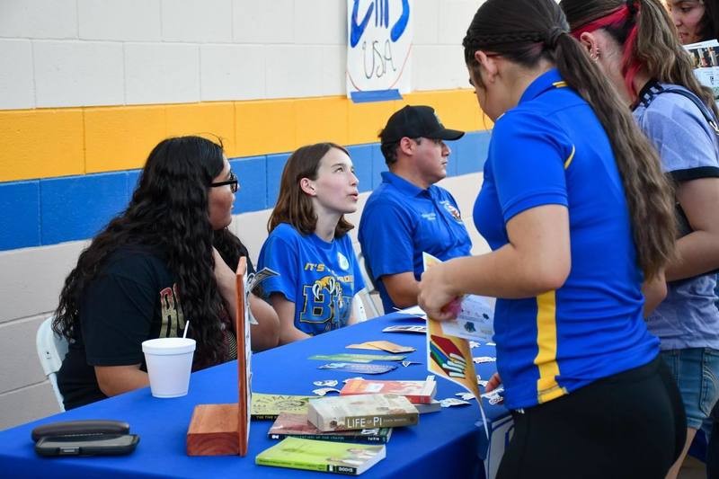 Students speak to other students at event
