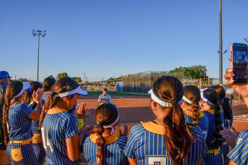 Brawley Softball huddles up on the field.