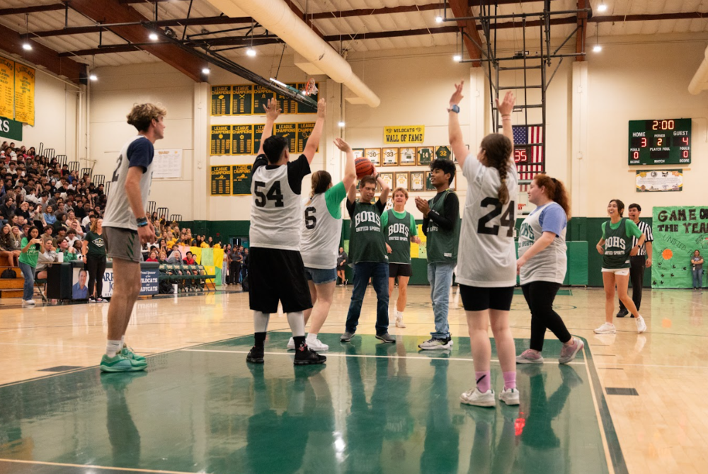 athletes playing basketball in a gym