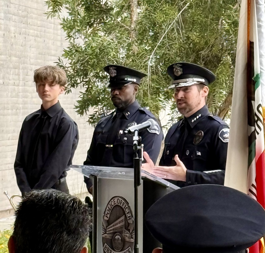 Brea PD Chief speaks at the podium with another officer to the right and BOHS student next to him
