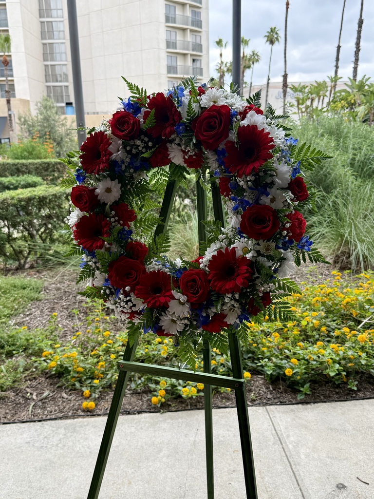 a memorial wreath with red, white and blue flowers