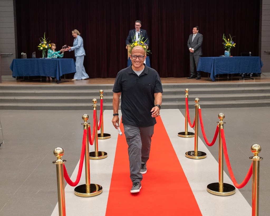 Teacher Paul Rivera walks the red carpet after receiving his award