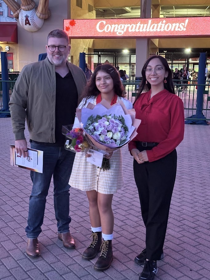 Camila stands in front of Angel Stadium with her Brea Junior High teachers