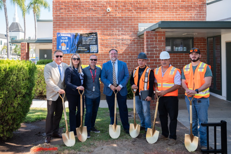 Photo of Superintendent with Contractors and others in orange vests holding gold shovels