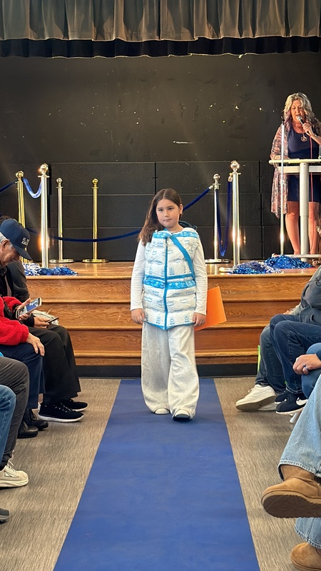 girl walks down runway stage wearing amazon puffer job