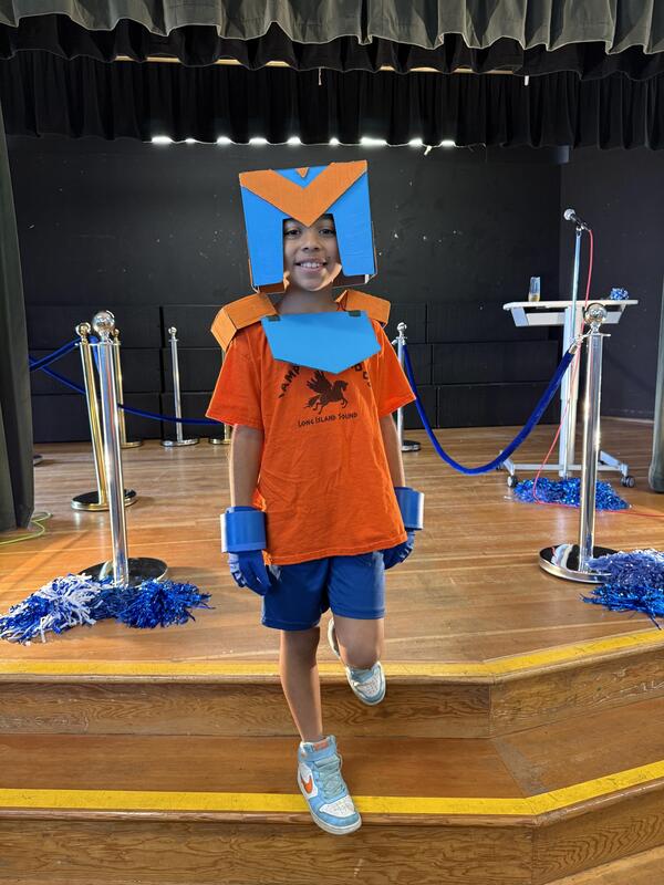 boy dressed in blue and orange box design
