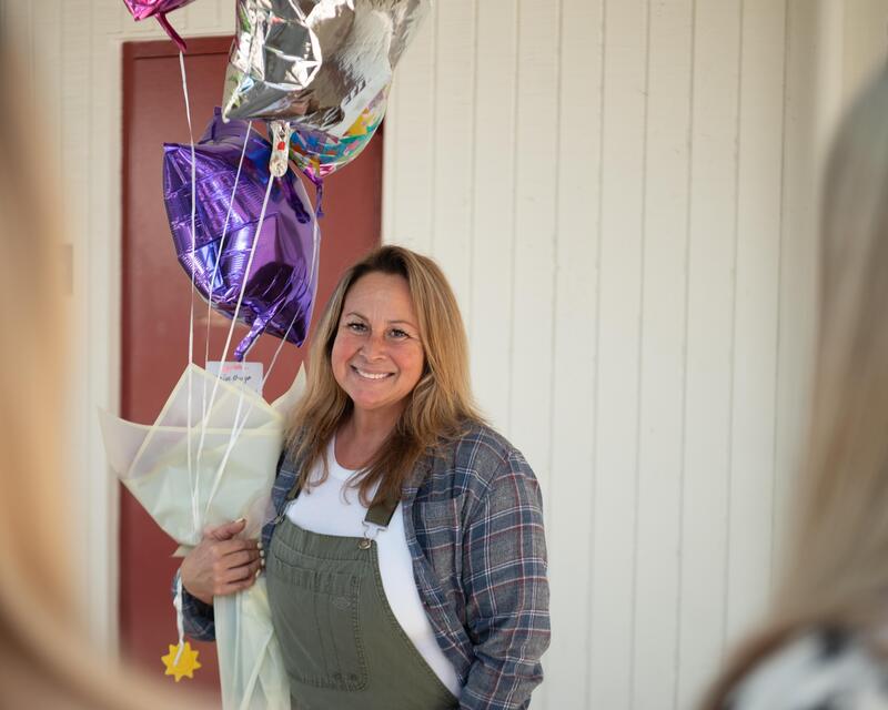 marisa arroyo stands with colorful balloons