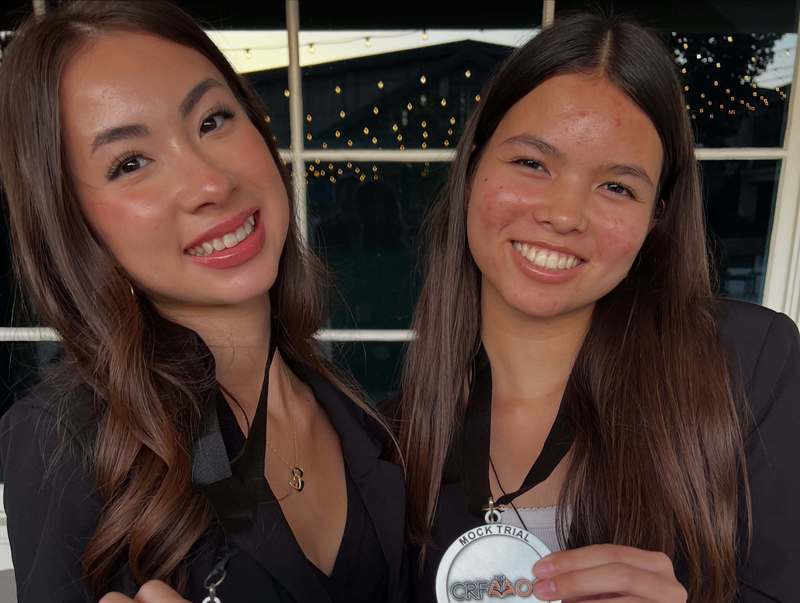 a close up photo of Maia Hammel and Dara Aung-Pfingsten holding medalions