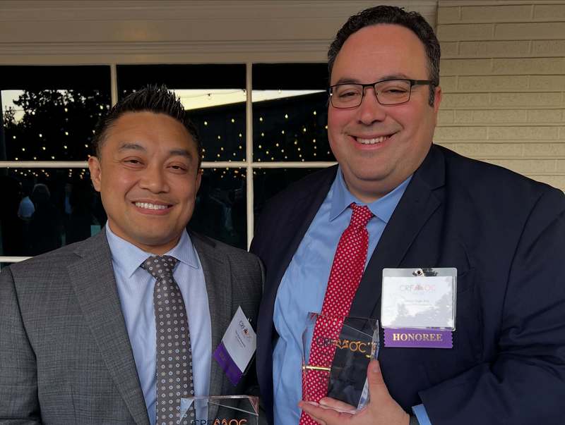 a close up photo of Bryan Clavecilla and James Voge holding awards