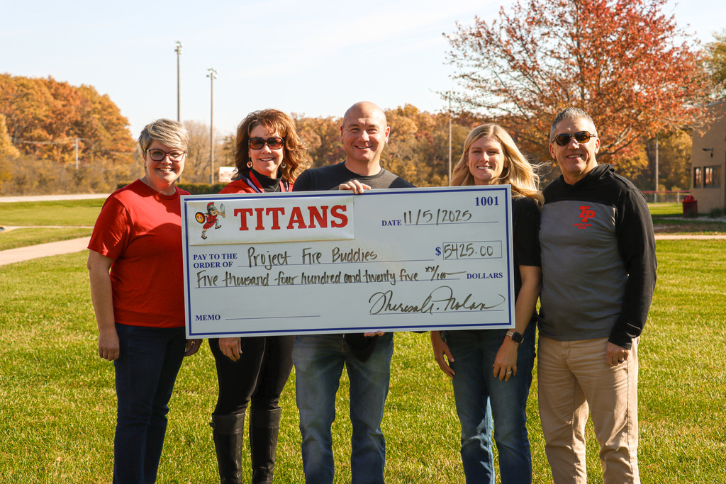 TPHS staff and Fire buddies founder holding check