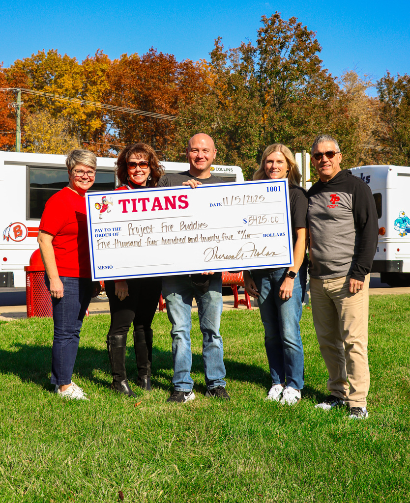 TPHS staff and Fire buddies founder holding check