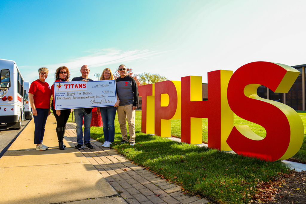 TPHS staff and Fire buddies founder holding check