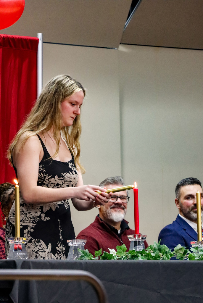 NHS Committee member lighting candle